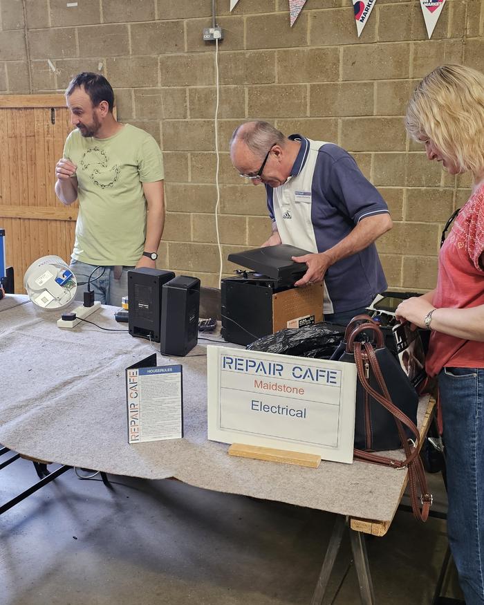 Volunteers at the Electrical repair table