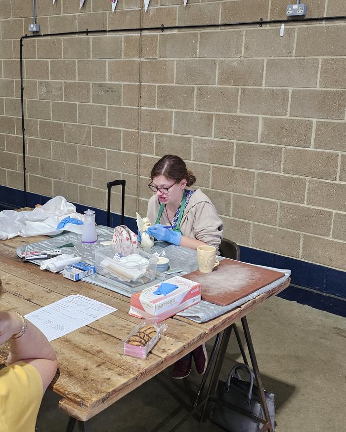Volunteer repairing a ceramic ornament